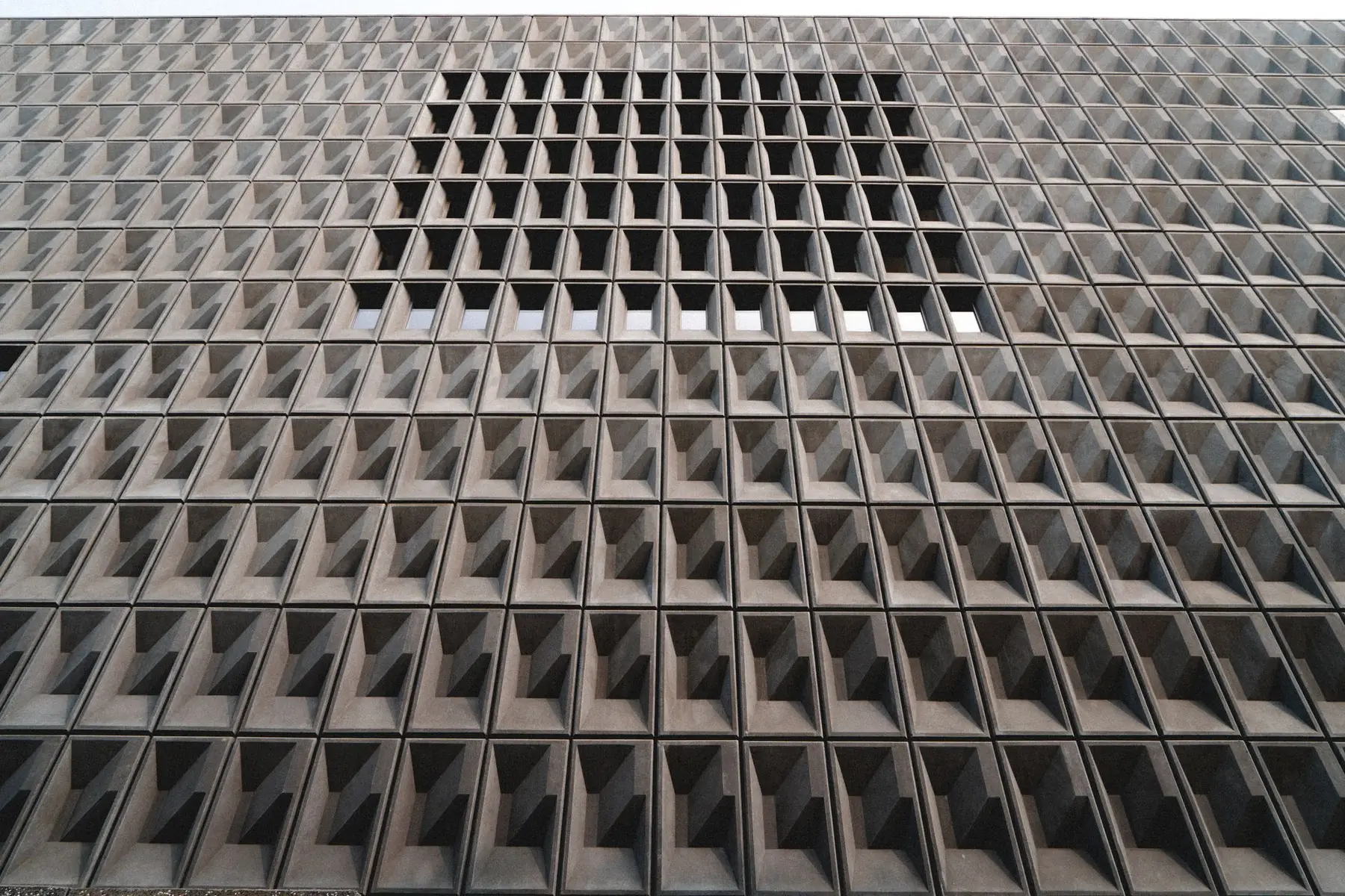 Full-bleed architectural photograph with oversized typography